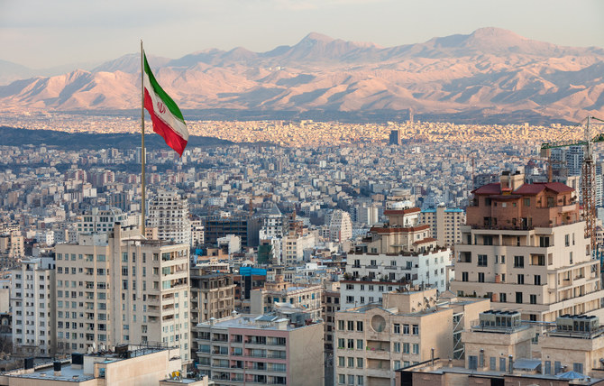 Tehran skyline with the Iranian flag flying.